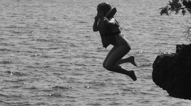 Flying Leap; photo of child jumping into water
